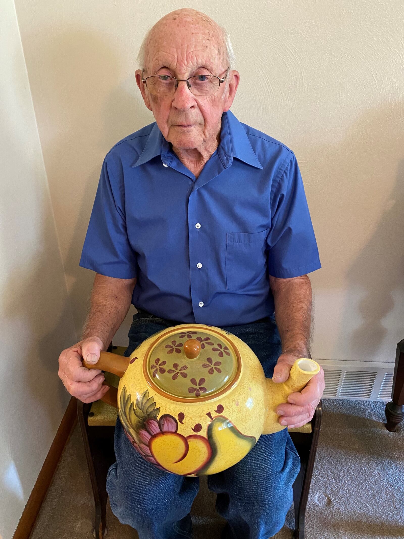 Bill Roop and one of his favorite teapots. CONTRIBUTED