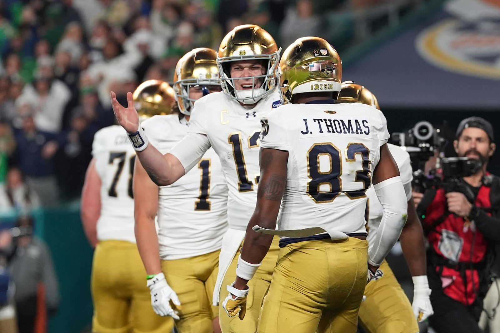 Notre Dame quarterback Riley Leonard (13) celebrates after scoring a touchdown during the second half of the Orange Bowl NCAA College Football Playoff semifinal game against Penn State, Thursday, Jan. 9, 2025, in Miami Gardens, Fla. (AP Photo/Rebecca Blackwell)