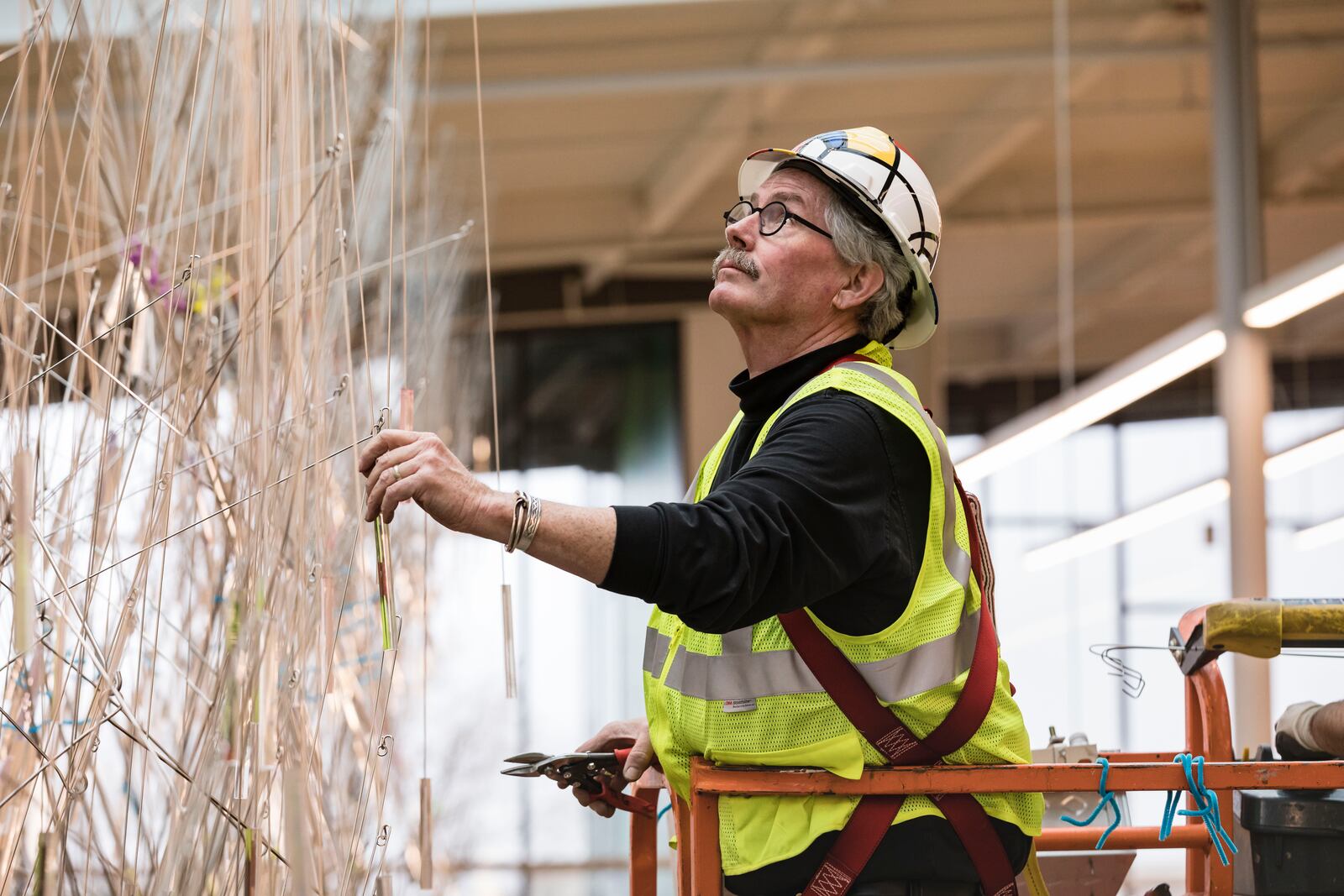 At "The Main Event" party patrons will get a sneak peak at the new downtown library and meet the artists who have created artwork for the new facility. 
Shown here is artist Terry Welker whose work,  Fractal Rain  is made of stainless steel wire and acrylic prisms. It will be located in the library's main atrium. 

Submitted photo  by Andy Snow.