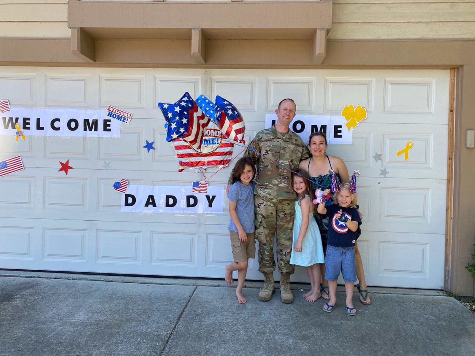 Senior Master Sgt. Bruce Haskin, a superintendent for the 88th Medical Support Squadron, is surrounded by his family upon return from deployment June 24. CONTRIBUTED PHOTO