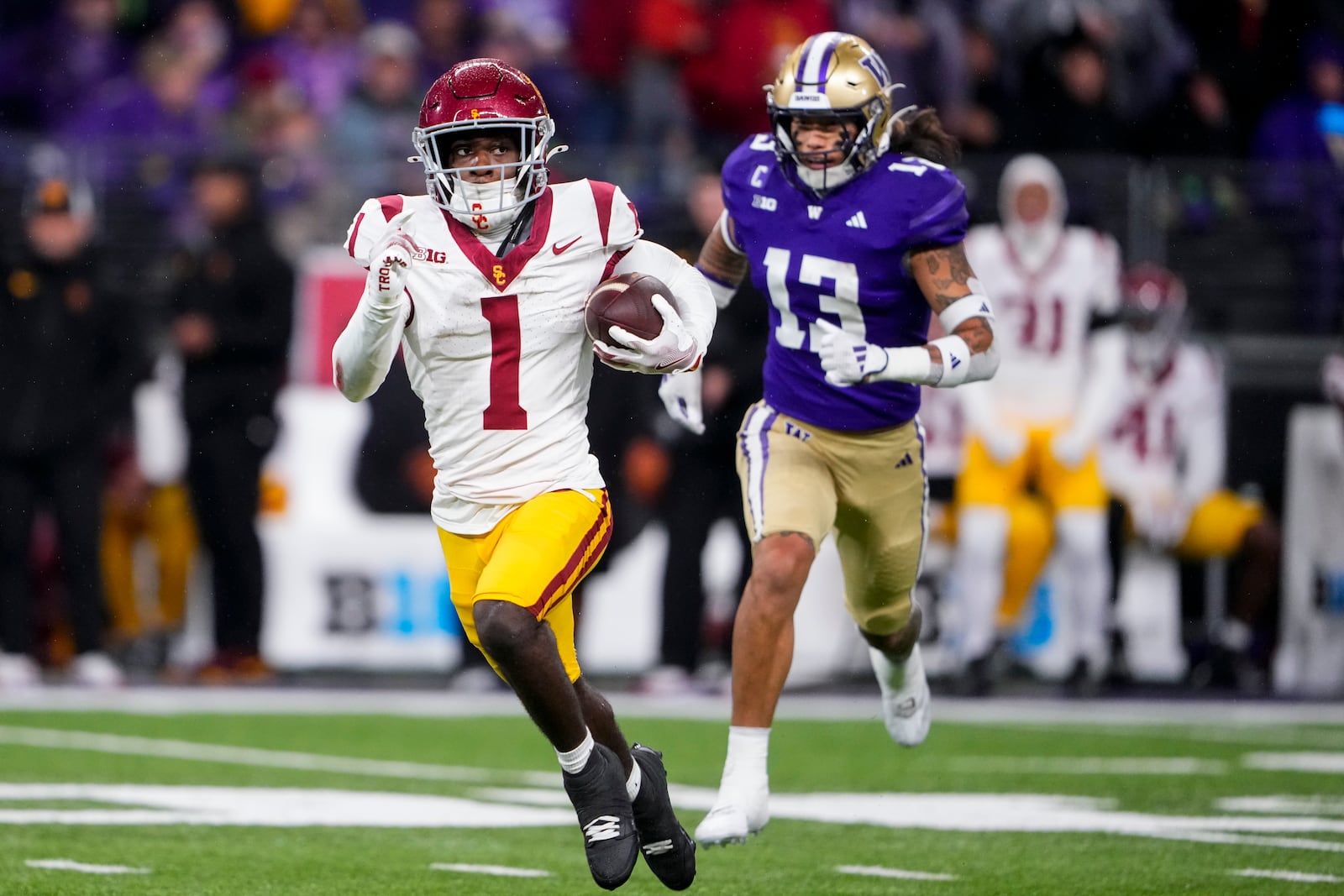 Southern California wide receiver Zachariah Branch (1) runs the ball against Washington safety Kamren Fabiculanan (13) during the second half of an NCAA college football game Saturday, Nov. 2, 2024, in Seattle. (AP Photo/Lindsey Wasson)