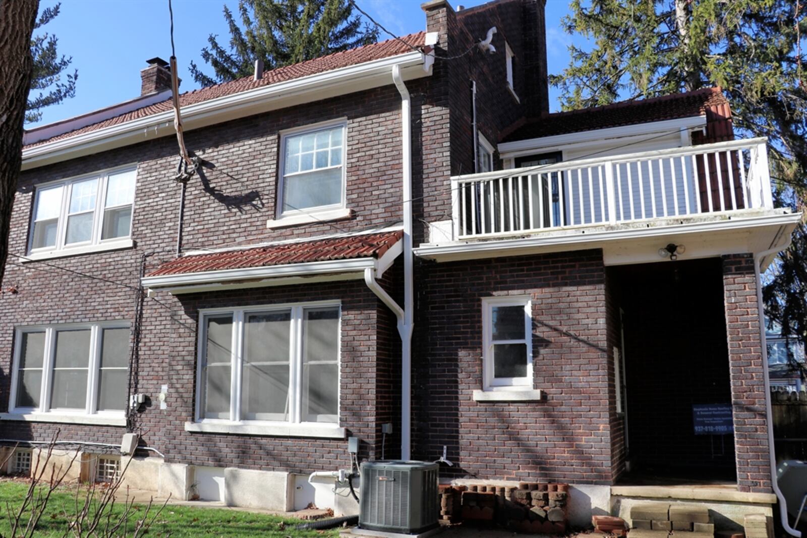 The two-story brick home has beautiful hardwood details, flexible living spaces and sits on a hill within the Grafton Hill Historic District.