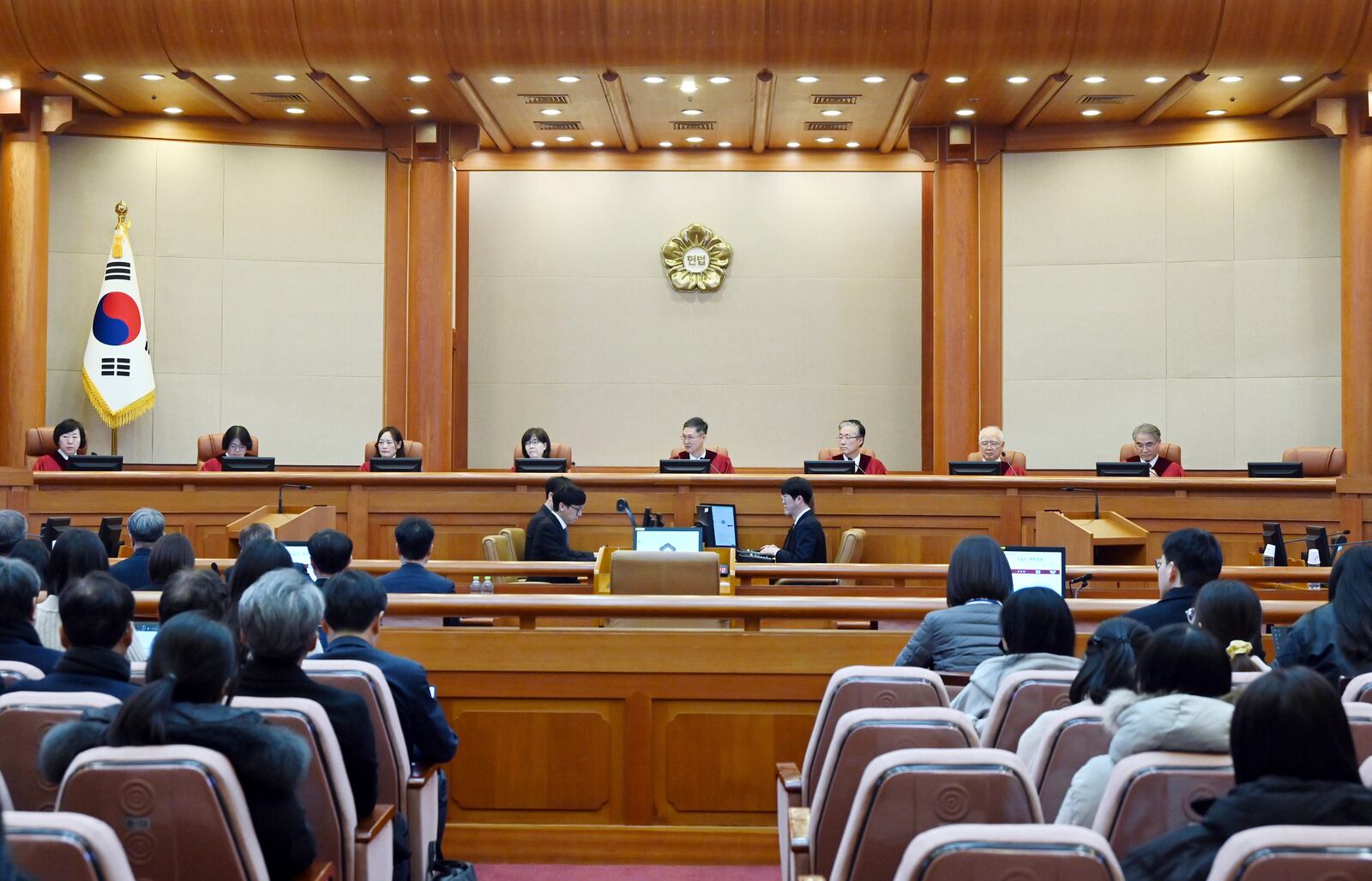 South Korea's Constitutional Court's judges, from left, Chung Kye-sun, Kim Bok-hyeong, Jung Jung-mi, Lee Mi-son, acting Chief Justice Moon Hyung-bae, Kim Hyung-du, Cheong Hyung-sik and Cho Han-chang sit for the first formal hearing of a trial on the validity of President Yoon Suk Yeol's impeachment by the National Assembly at the constitutional court of Korea in Seoul, South Korea, Tuesday, Jan. 14, 2025. (Kim Min-Hee/Pool Photo via AP)