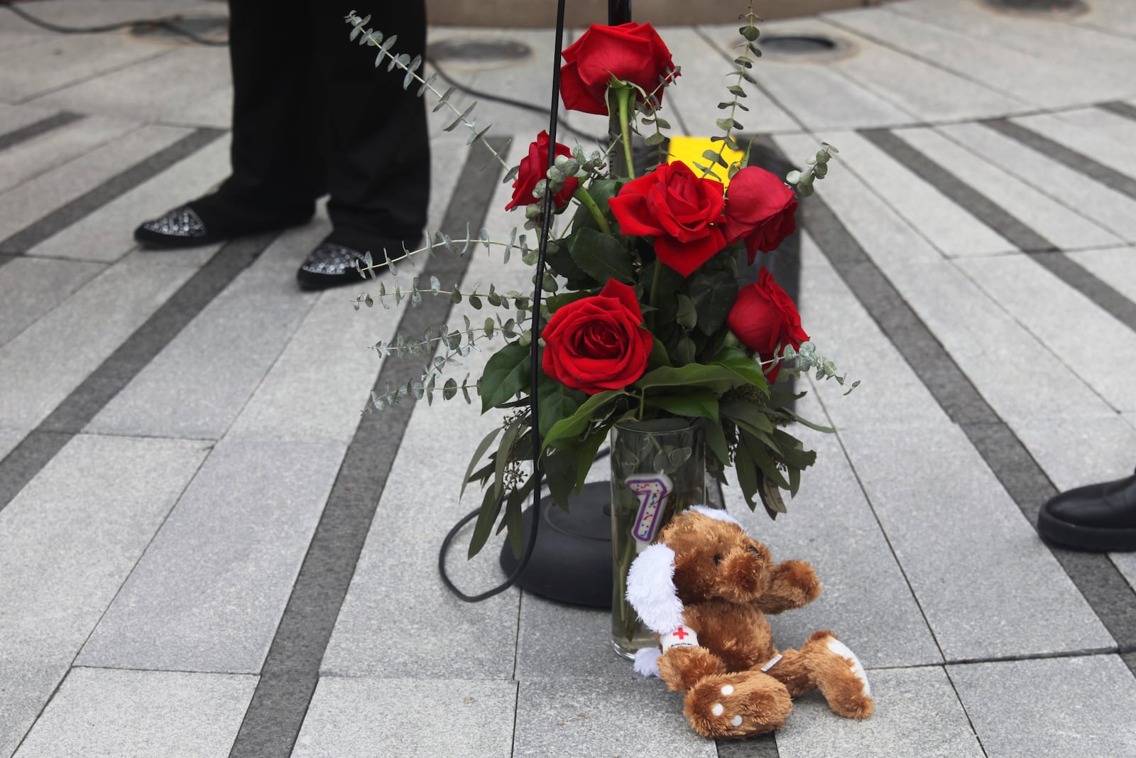 A donated vase of red roses honors victims of the deadly collision between a passenger airliner and an Army helicopter that occurred the day prior, Thursday, Jan. 30, 2025, at the Law Enforcement Memorial in Wichita, Kan., where the airline passenger flight originated. (AP Photo/John Hanna)