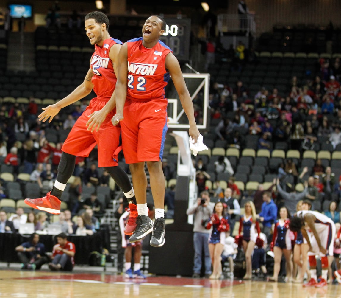 Dayton's Devin Oliver, left, and Kendall Pollard celebrate a victory against Duquesne on Saturday, Feb. 22, 2014, at the CONSOL Energy Center in Pittsburgh, Pa. David Jablonski/Staff