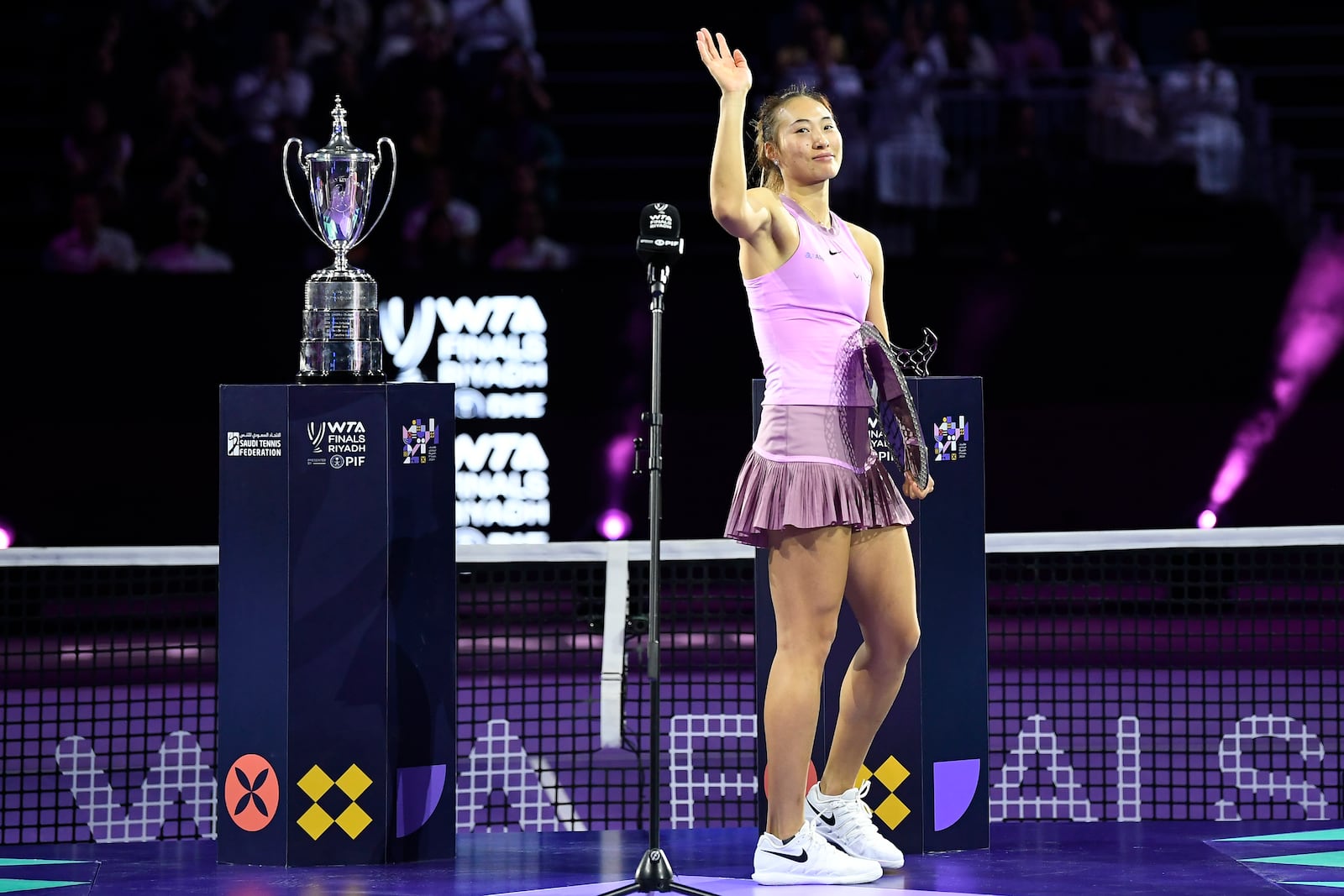 China's Qinwen Zheng waves as she holds her trophy after losing against Coco Gauff of the U.S. in their women's singles final match of the WTA finals at the King Saud University Indoor Arena, in Riyadh, Saudi Arabia, Saturday, Nov. 9, 2024. (AP Photo)