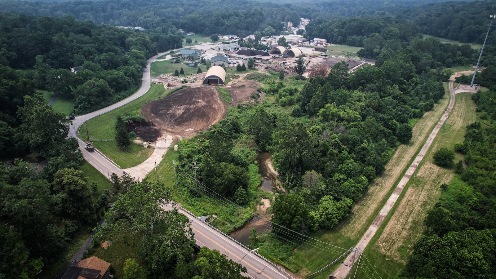 Sugar Creek runs on the north end of the Tom's Mulch property, in the right half of the photo. The state of Ohio sued the Sugarcreek Twp. landscaping company over alleged polluting of Sugar Creek. JIM NOELKER/STAFF