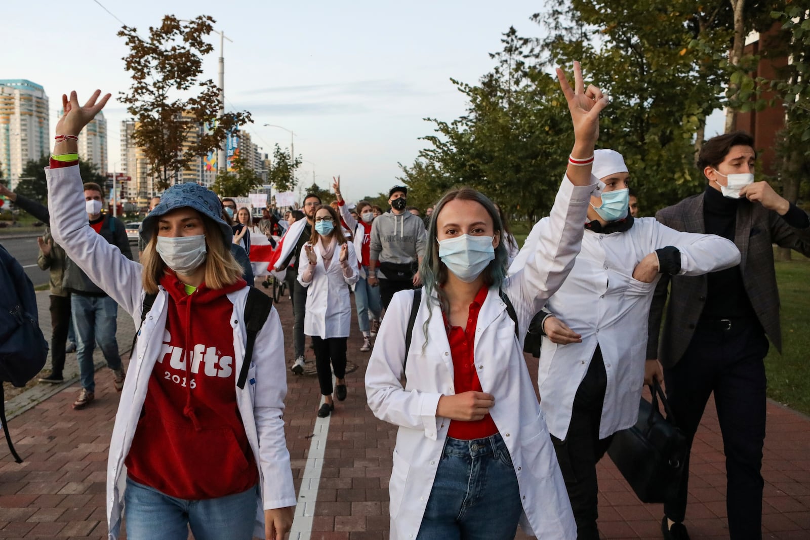 Belarusian medical workers gesture during a rally in support of Maria Kolesnikova, and other members of the Coordination Council created by the opposition to facilitate talks with Lukashenko on a transition of power, was detained Monday in the capital of Minsk with two other council members, in Minsk, Belarus, Wednesday, Sept. 9, 2020. The leading opposition candidate in Belarus' disputed presidential election said Wednesday that the political tension in her country should be solved internally, by the Belarusian people, but she did not exclude the need for future international mediation. (AP Photo)