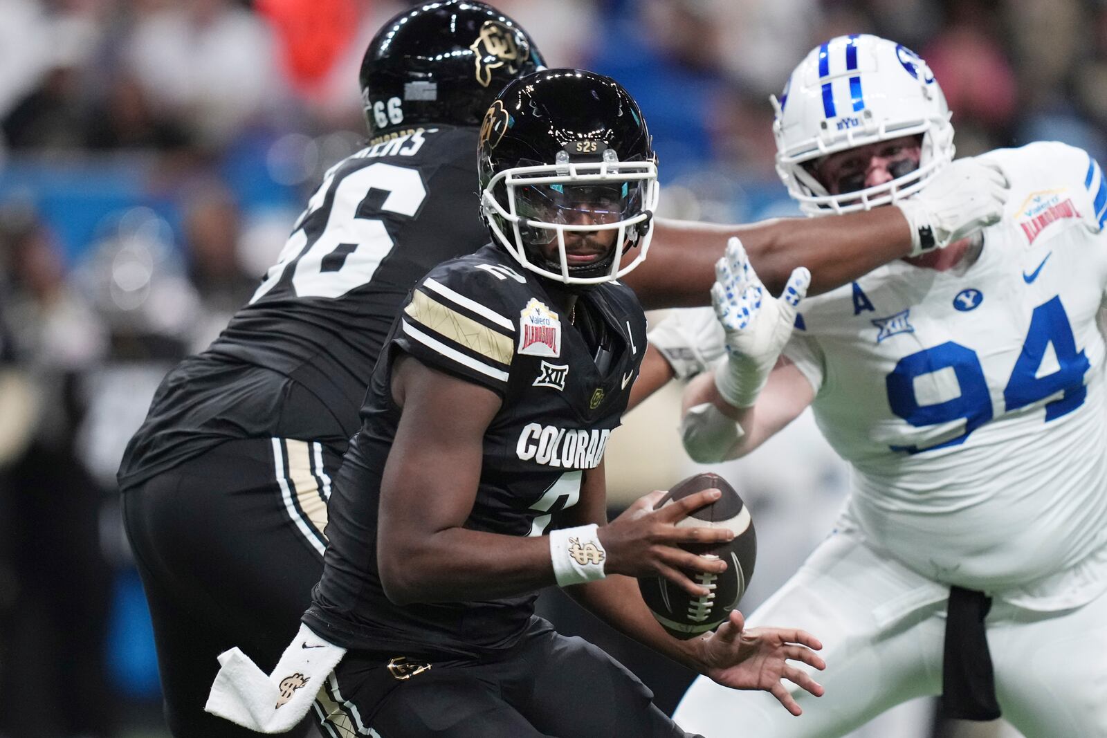 Colorado quarterback Shedeur Sanders (2) scrambles against BYU during the first half of the Alamo Bowl NCAA college football game, Saturday, Dec. 28, 2024, in San Antonio. (AP Photo/Eric Gay)