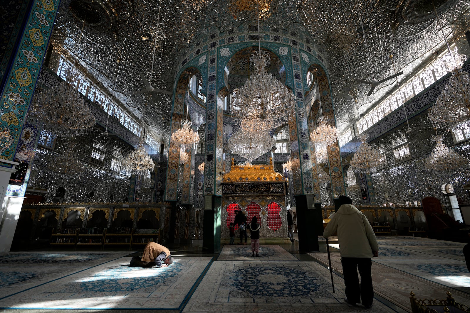 Syrians pray at the shrine of al-Sayydah Zeinab, the grand daughter of Prophet Mohammed, south of Damascus, Syria, Wednesday, Dec. 18, 2024. (AP Photo/Hussein Malla)