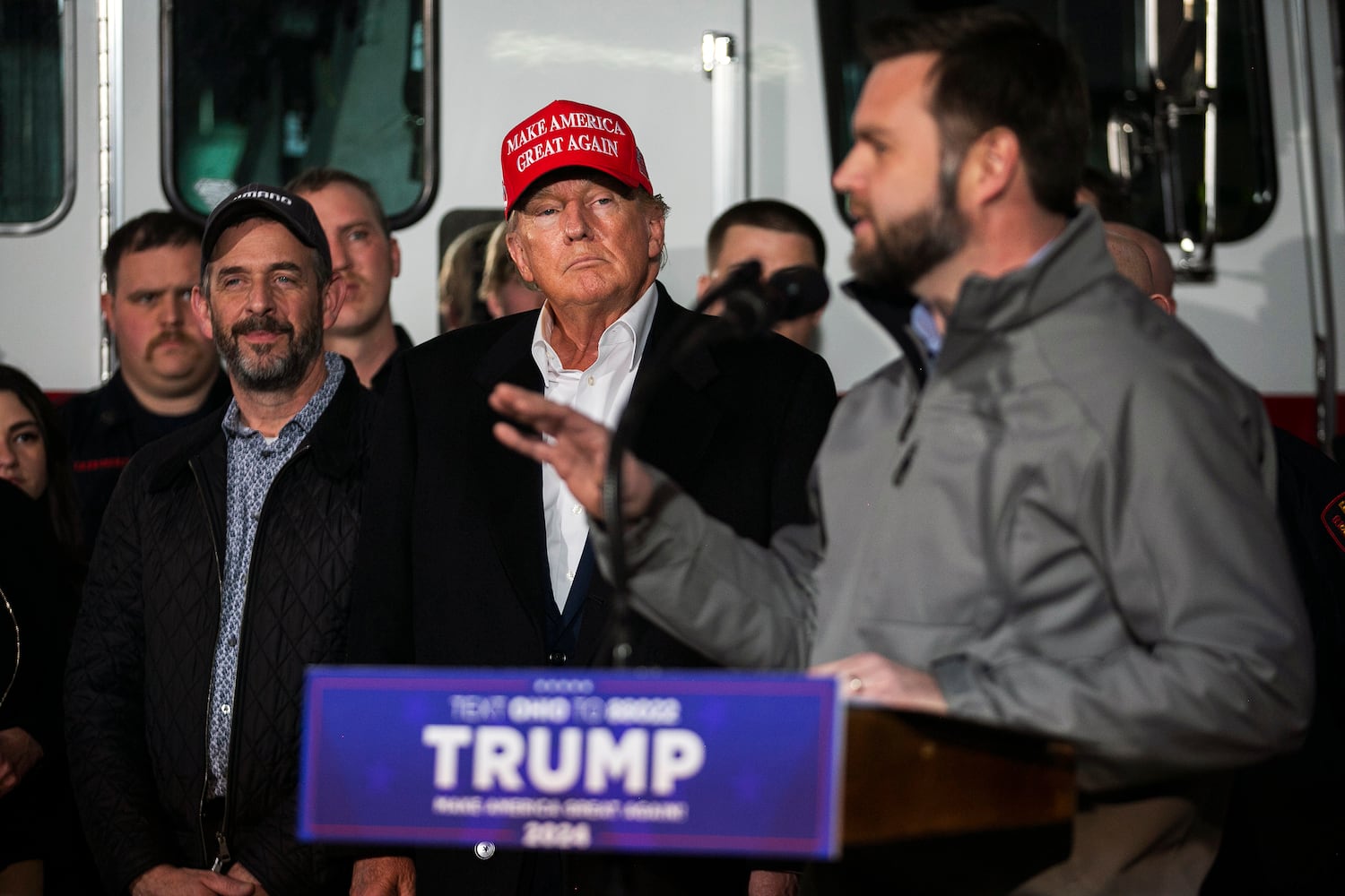 Senator J.D. Vance (R-Ohio) speaks as former President Donald Trump looks on during a visit to the train derailment site in East Palestine, Ohio, on Wednesday, Feb. 22, 2023.  (Maddie McGarvey/The New York Times)