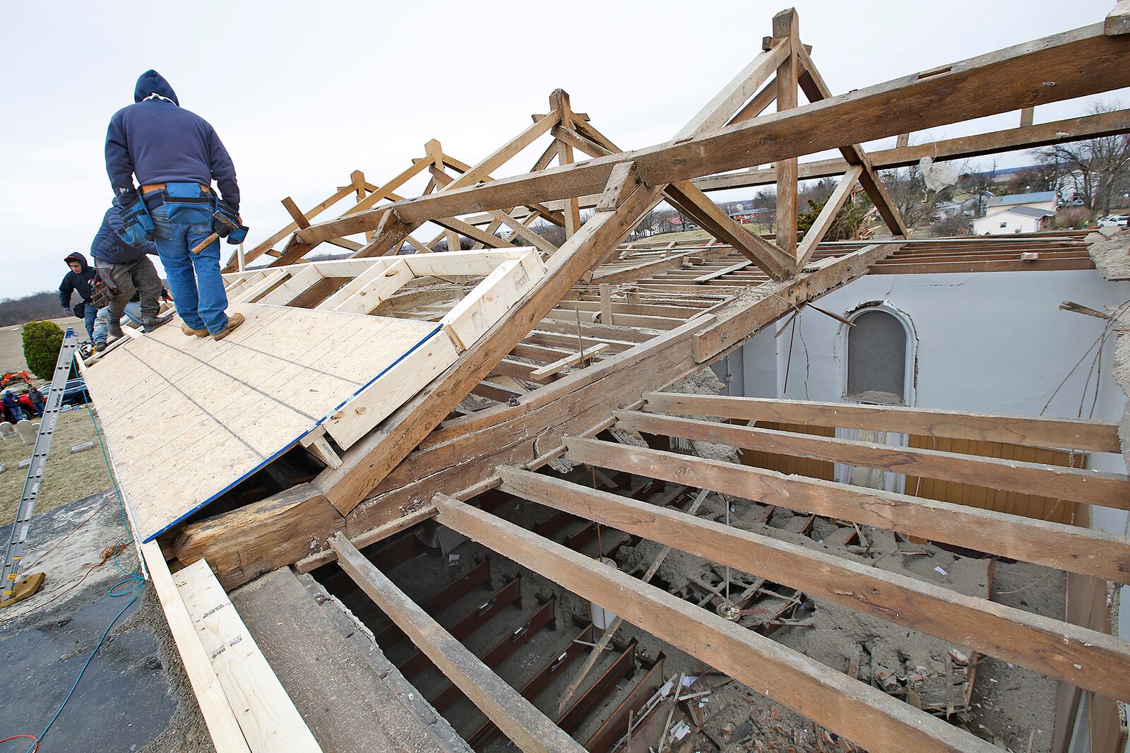 A crew from Guardian Restoration works on the roof of the Fletcher Chapel Church Friday, March 1, 2024. The church built in 1883 was severely damaged in Wednesday's tornado. BILL LACKEY/STAFF