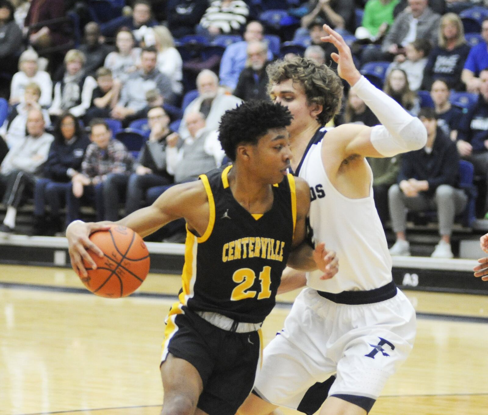 Centerville senior Kaleb Mitchell (21) draws Fairmont defender Kellan Bochenek. Centerville defeated host Fairmont 46-44 in a boys high school basketball game at Trent Arena on Friday, Feb. 8, 2019. MARC PENDLETON / STAFF