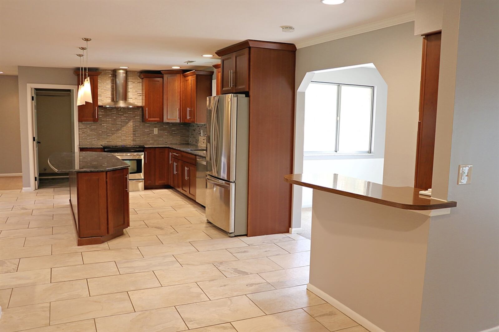 The kitchen’s redesign allows for planning space, a breakfast area and a convenient bar near the formal dining area and family room. 