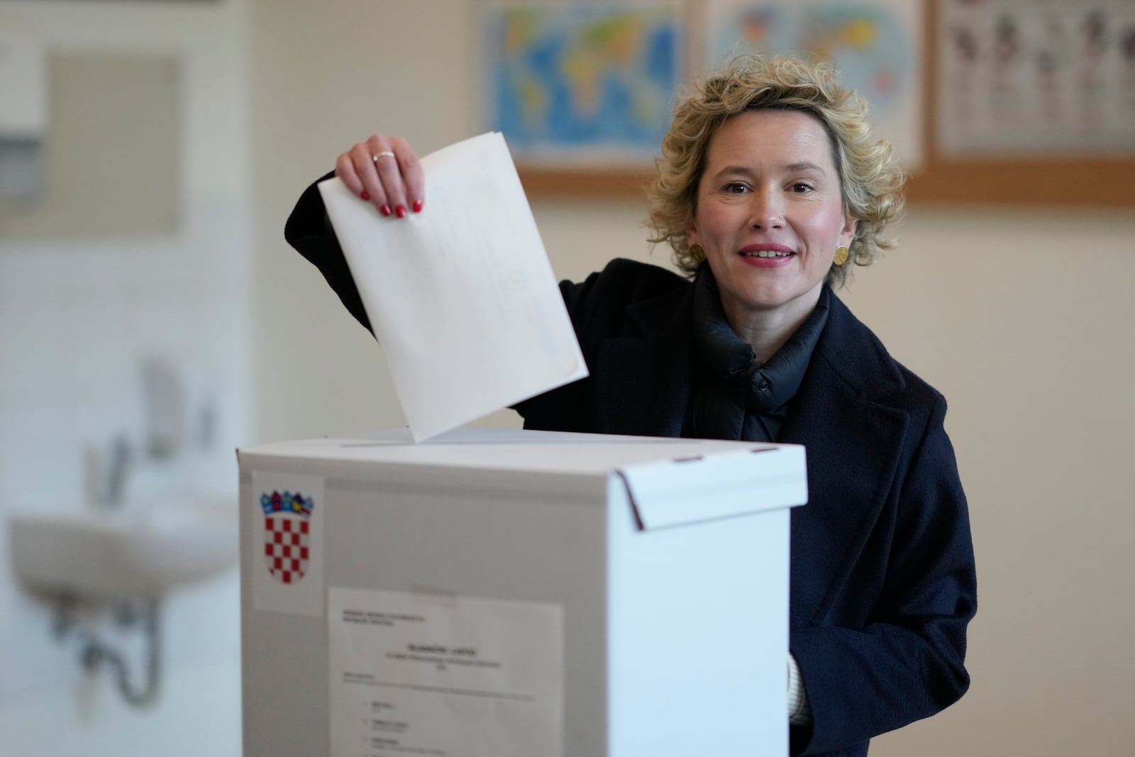 Ivana Kekin, left-green candidate of the (Mozemo) "We Can" party casts her ballot during presidential elections, at a polling station in Zagreb, Croatia, Sunday, Dec. 29, 2024. (AP Photo/Darko Bandic)