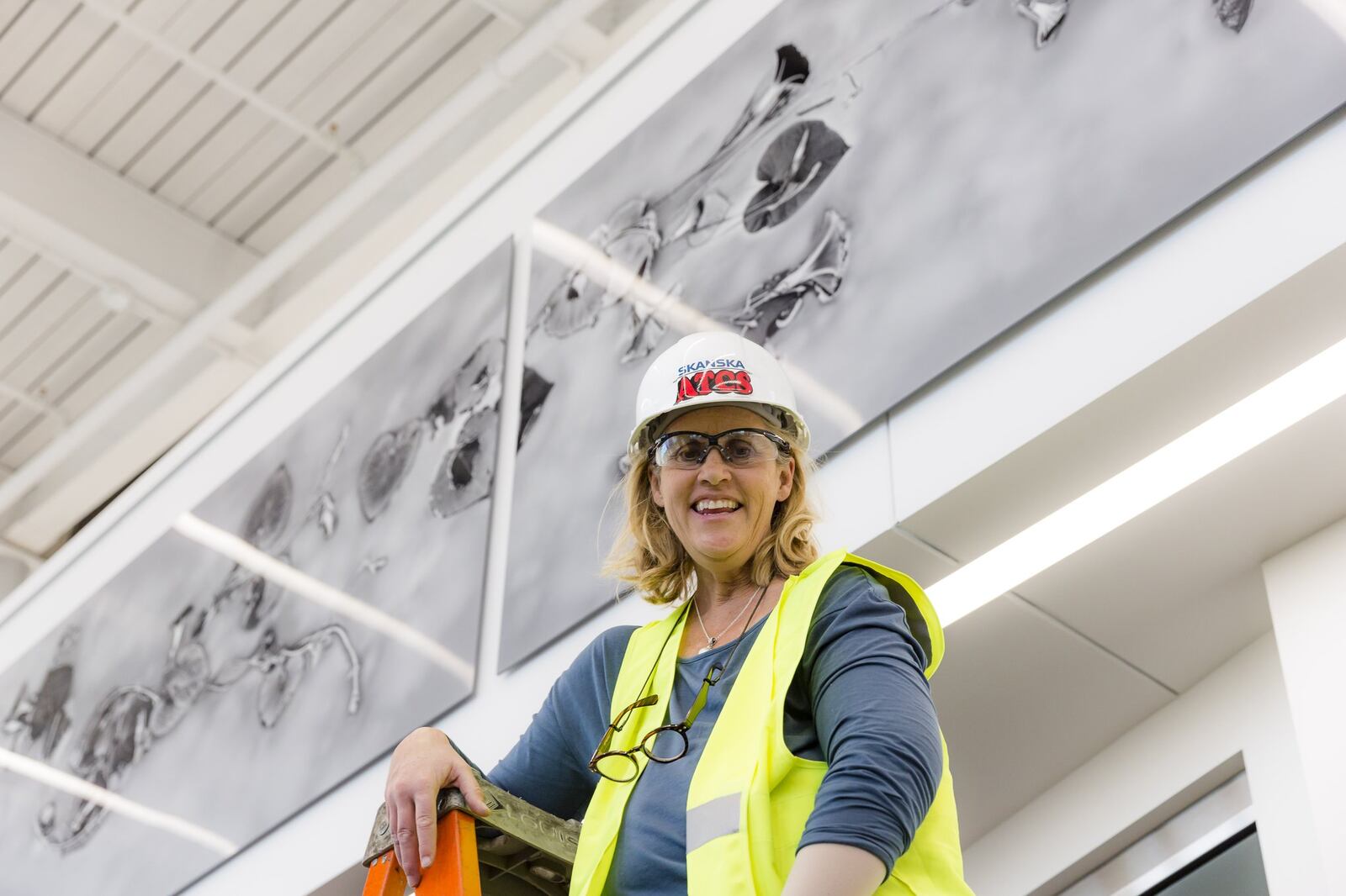 Dayton artist Paula Willmot Kraus is pictured installing her inkjet print, “Morning Glory,” on the new library’s second floor. CONTRIBUTED PHOTO BY ANDY SNOW