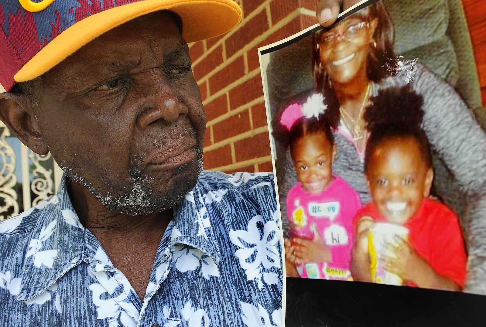 James Phillips looks at a photo of his late wife, Evelyn Phillips-Simon, and his great niece Joshlyn Marie Johnson and great nephew Larry Darnell O'Neil III at his home Wednesday, Aug. 4, 2021.  Joshlyn’s and Larry’s decomposing bodies were found the prior week in the trunk of a car driven by their aunt in Essex, Maryland, about eight miles outside Baltimore. MARSHALL GORBY\STAFF