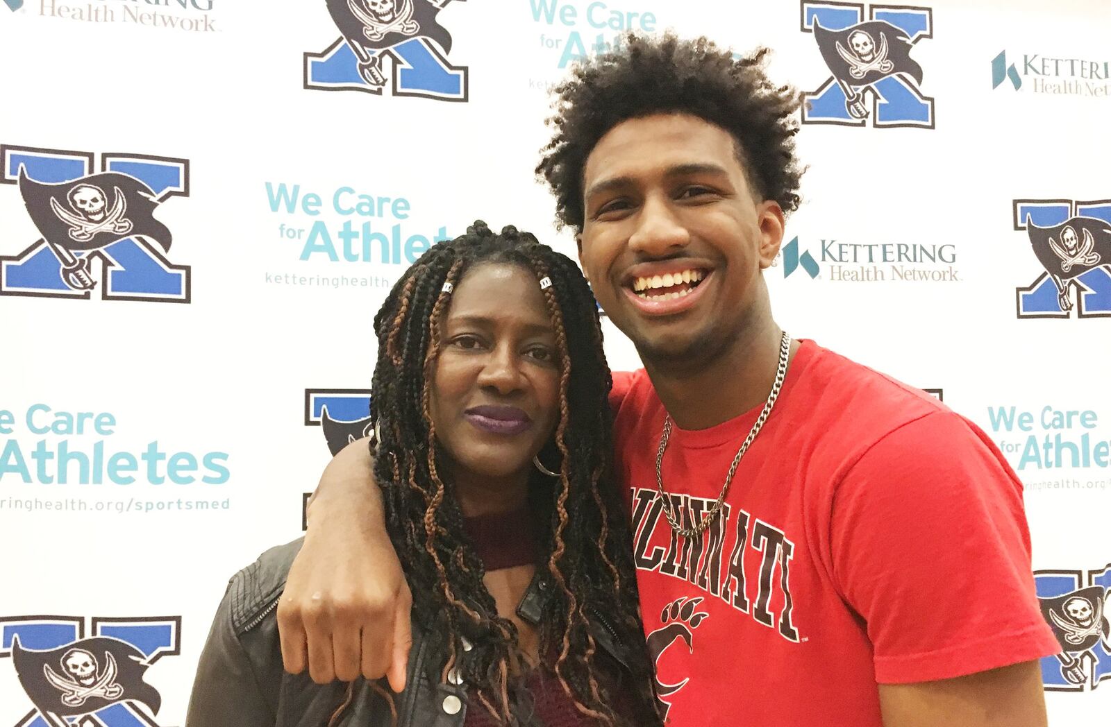 Samarie Curtis huddles with his mother Revonne Arrington after he signed to play basketball for the University of Cincinnati at Xenia High School on Wednesday, Nov. 14, 2018. MARC PENDLETON / STAFF