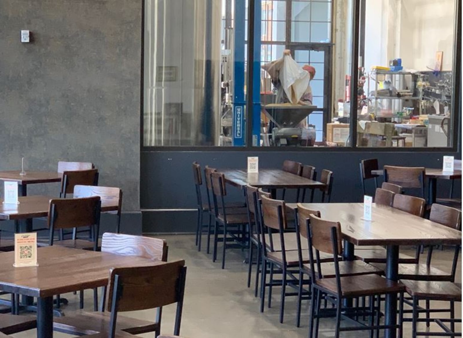 A view of the Cartridge Brewing dining area and a window to watch the beer being brewed. ED RICHTER/STAFF