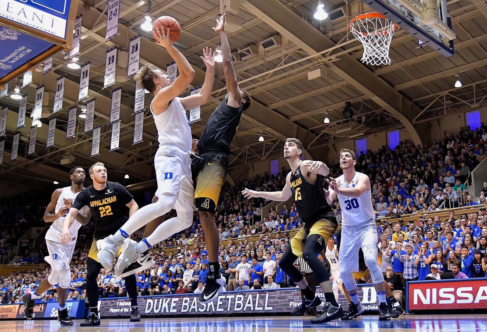 Luke Kennard (5) of Duke drives to the basket against Isaac Johnson (0) of Appalachian State during a Nov. 26 game at Cameron Indoor Stadium in Durham, N.C. GRANT HALVERSON/GETTY IMAGES