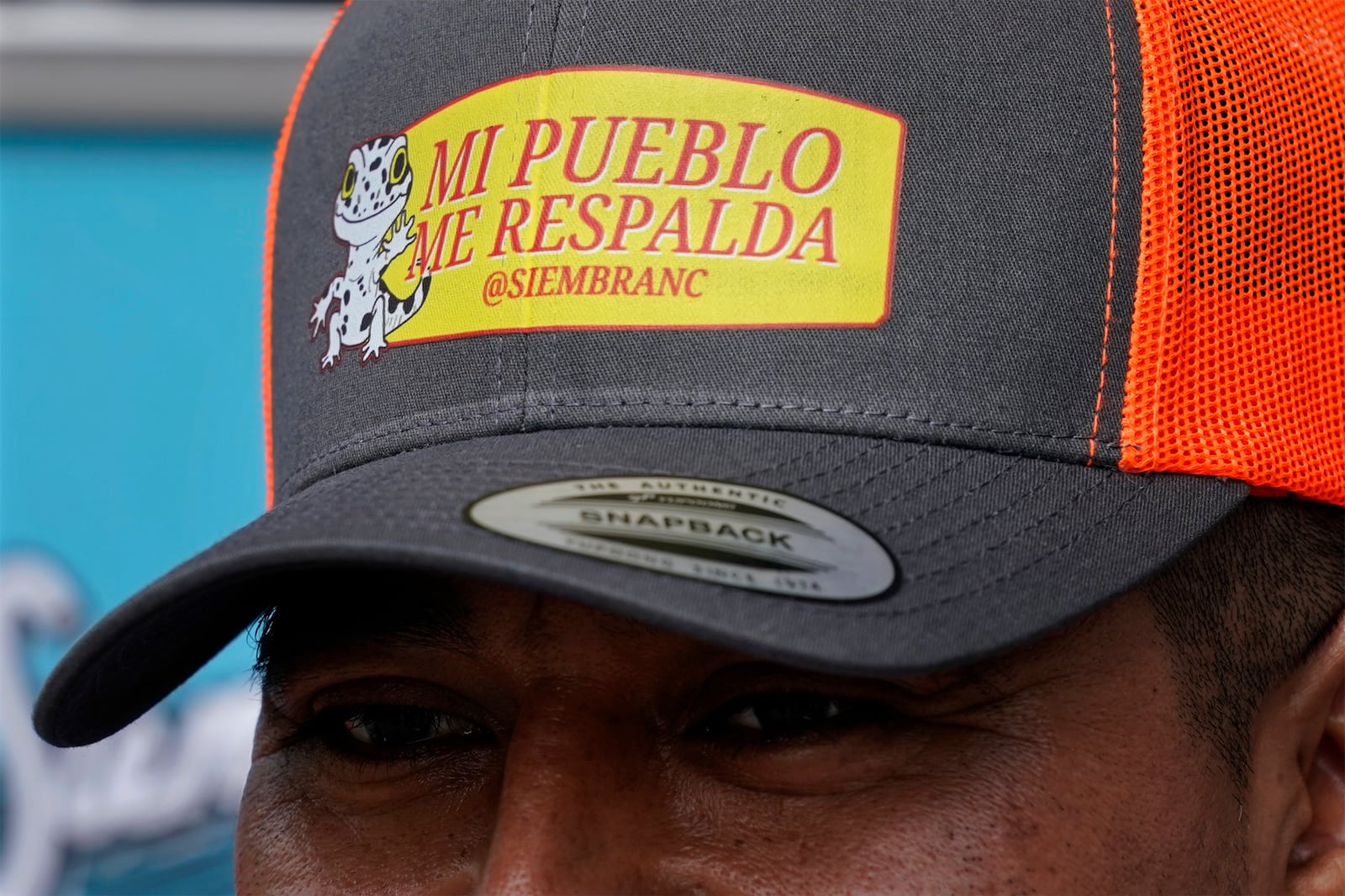 A volunteer with Siembra NC, a support group for Latinos, wears a hat that says "my people support me" during a voter engagement event for the Latino community in Greensboro, N.C., Saturday, Sept. 21, 2024. (AP Photo/Chuck Burton)