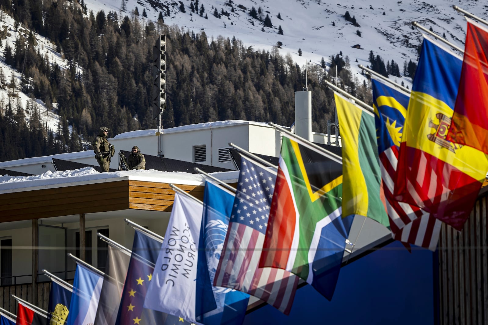 Special police is on guard on the roof of the congress hotel prior to the 55th annual meeting of the World Economic Forum, WEF, in Davos, Switzerland, Monday, Jan. 20, 2025. (Michael Buholzer/Keystone via AP)