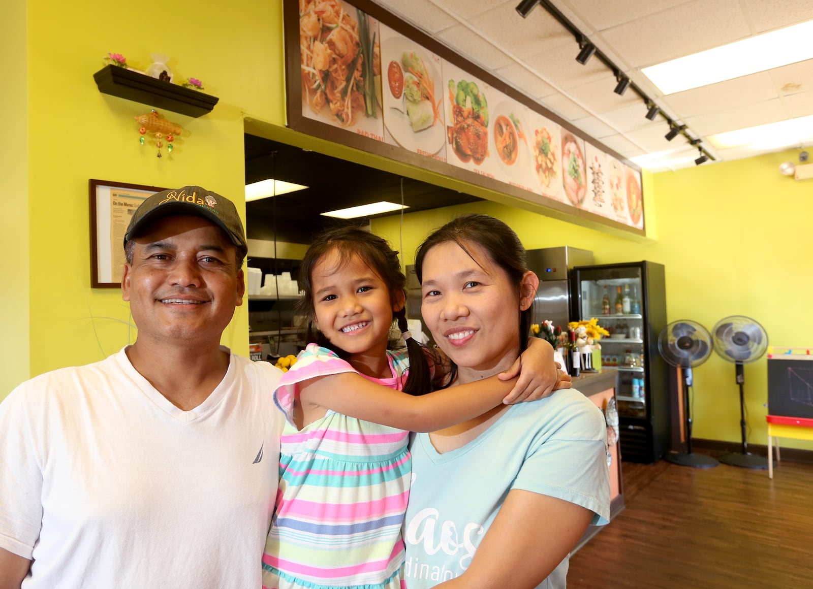 Pirom Tintong (left) and his wife, Pimkul (right) are the owners of Nida Thai Cuisine is located at 853 E. Franklin St. in Centerville. At center is their daughter, Panida, 5.  LISA POWELL / STAFF