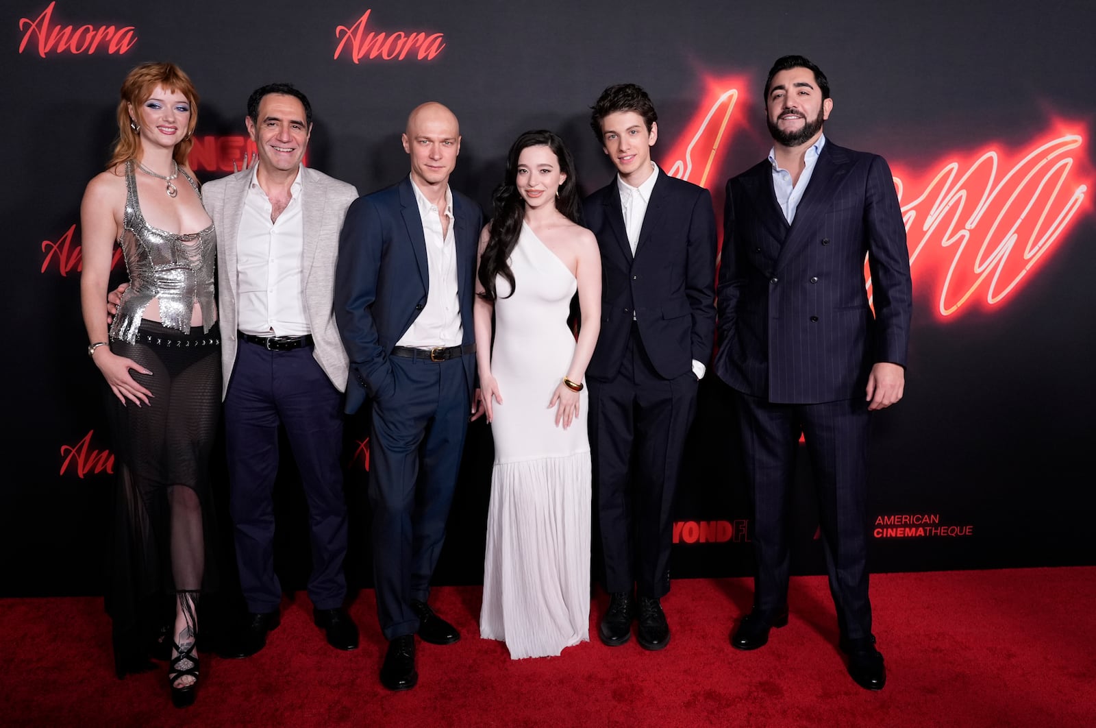 FILE - Cast members, from left, Lindsey Normington, Karren Karagulian, Yura Borisov, Mikey Madison, Mark Eydelshteyn and Vache Tovmasyan pose together at the premiere of the film "Anora," Tuesday, Oct. 1, 2024, at the Vista Theatre in Los Angeles. (AP Photo/ Chris Pizzello, File)