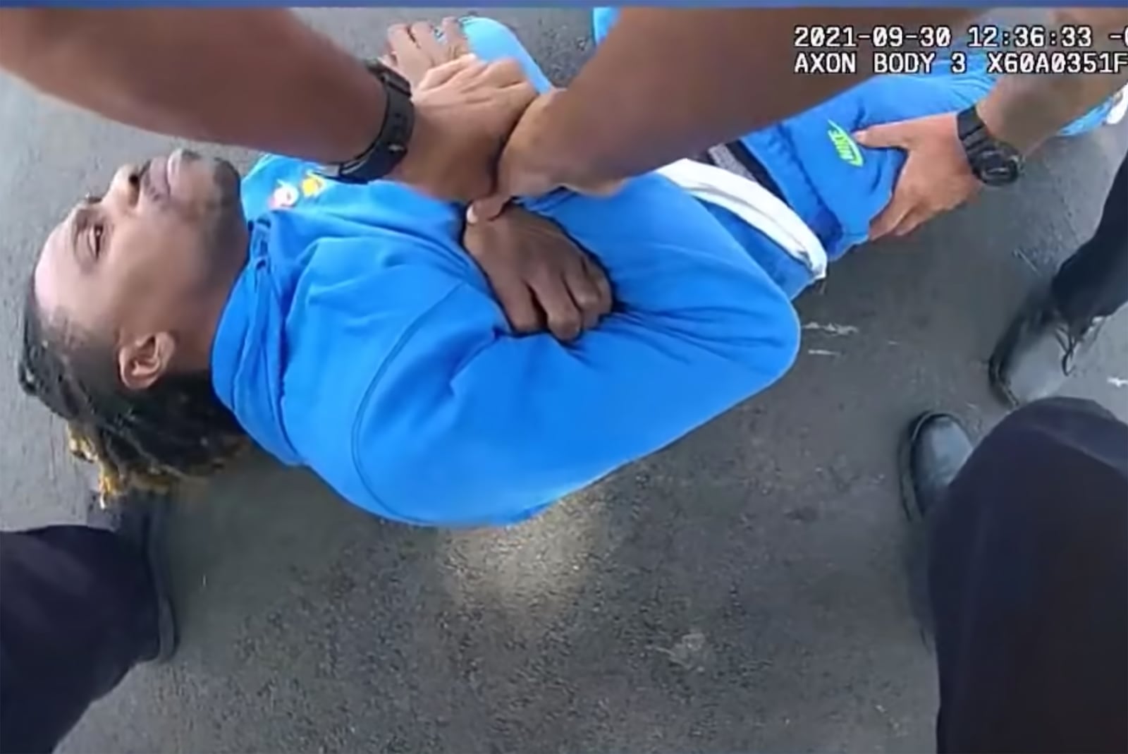 In an image provided by the Dayton Police Department, a frame from a bodycam video released by the Dayton Police Department shows Clifford Owensby being restrained by police officers on Sept. 30, 2021. A Black man who was pulled from a car by police officers while yelling “I’m paraplegic” filed a complaint with the NAACP, the organization said, as the police in Dayton, Ohio, said they were investigating what had happened during the stop. (Dayton Police Department via The New York Times) -- FOR EDITORIAL USE ONLY. --