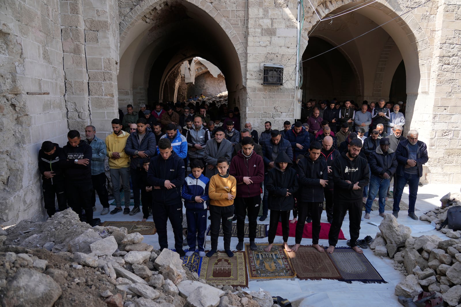 Palestinians take part in Friday prayers in the ruins of the Omari Mosque that was partially destroyed by Israeli bombardment, ahead of the start of the Muslim holy month of Ramadan in Gaza City, Gaza Strip, Friday, Feb. 28, 2025. (AP Photo/Abdel Kareem Hana)