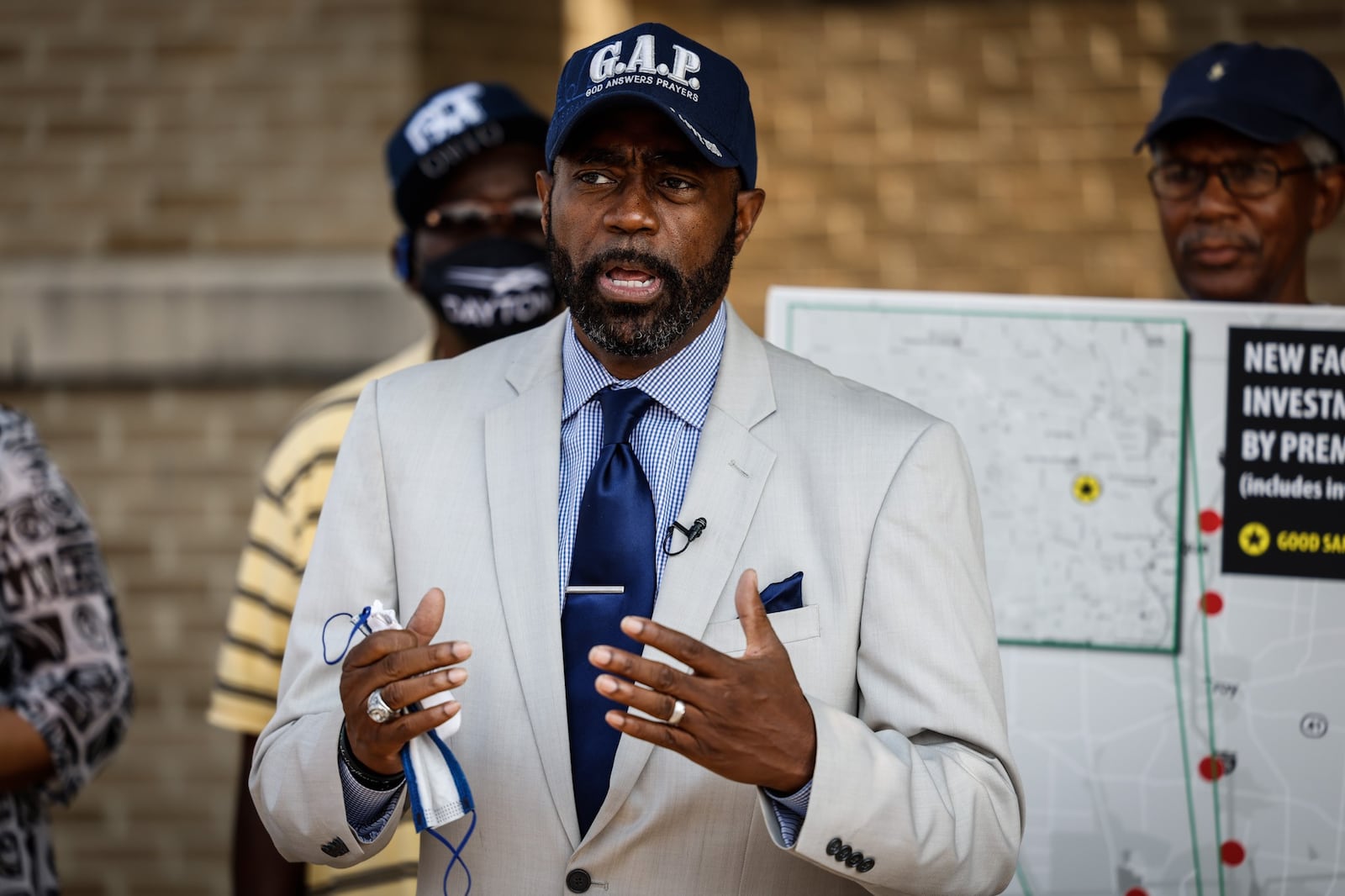 Rev. Rockney Carter talks to the media and protesters about Premier Health's plan to build an urgent care and medical center at the site of the demolish Good Sam Hospital. JIM NOELKER/ STAFF