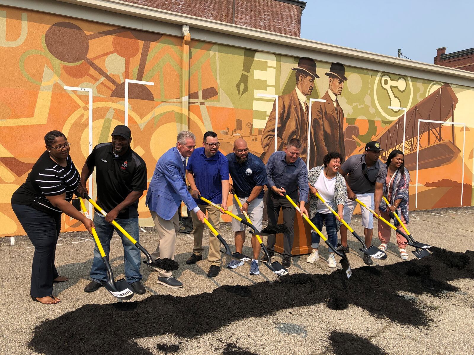 Local business owners take part in the official "groundbreaking" for the new food hall W. Social Tap & Table in the Historic Wright Dunbar Business District. CORNELIUS FROLIK / STAFF