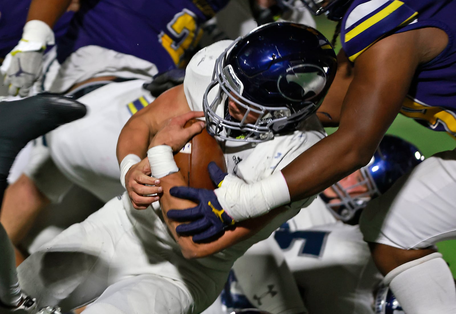 Fairmont's Logan Doty is tackled by the Springfield defense as he carries the ball. BILL LACKEY/STAFF