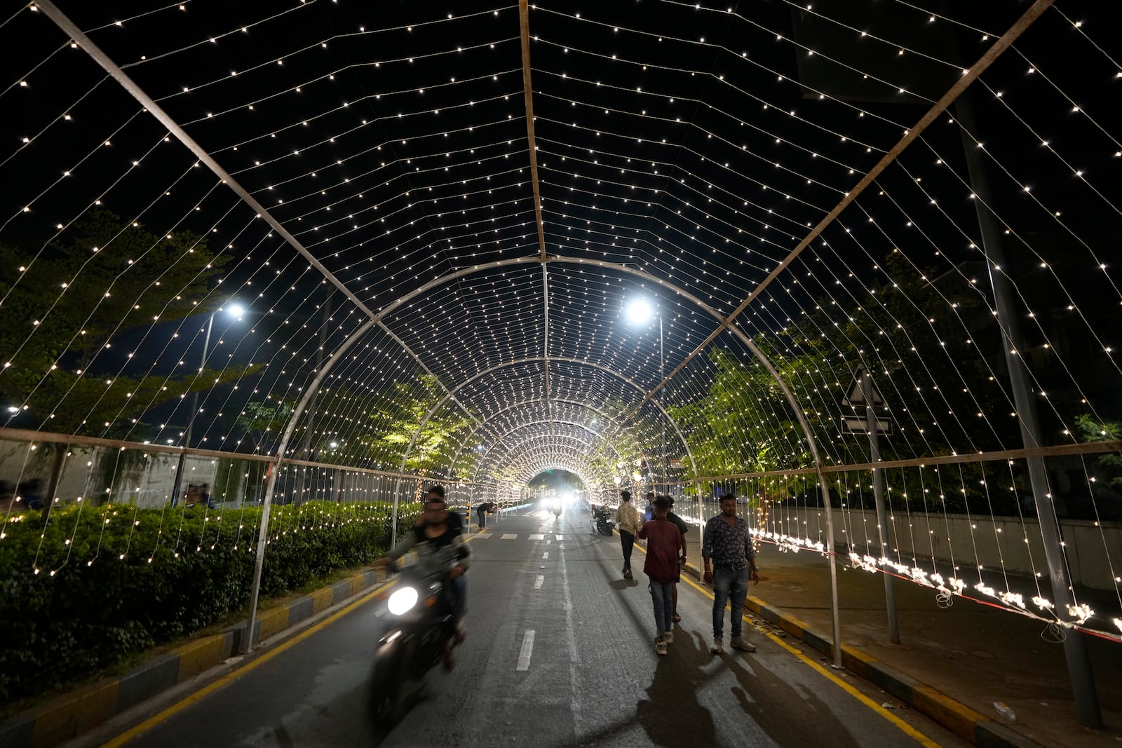 Commuters move on an illuminated road ahead of the Hindu festival of lights Diwali in Ahmedabad, India, Thursday, Oct. 31, 2024. (AP Photo/Ajit Solanki)