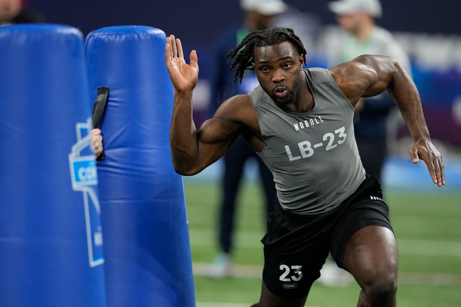 Wisconsin linebacker Maema Njongmeta runs the 40-yard dash at the NFL football scouting combine, Thursday, Feb. 29, 2024, in Indianapolis. (AP Photo/Darron Cummings)