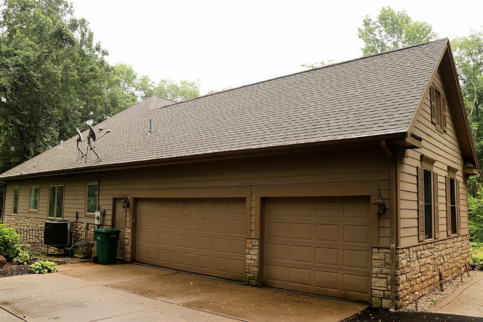 A gated, paved driveway curves among the trees to the side-entry, 3-car garage. CONTRIBUTED PHOTO BY KATHY TYLER