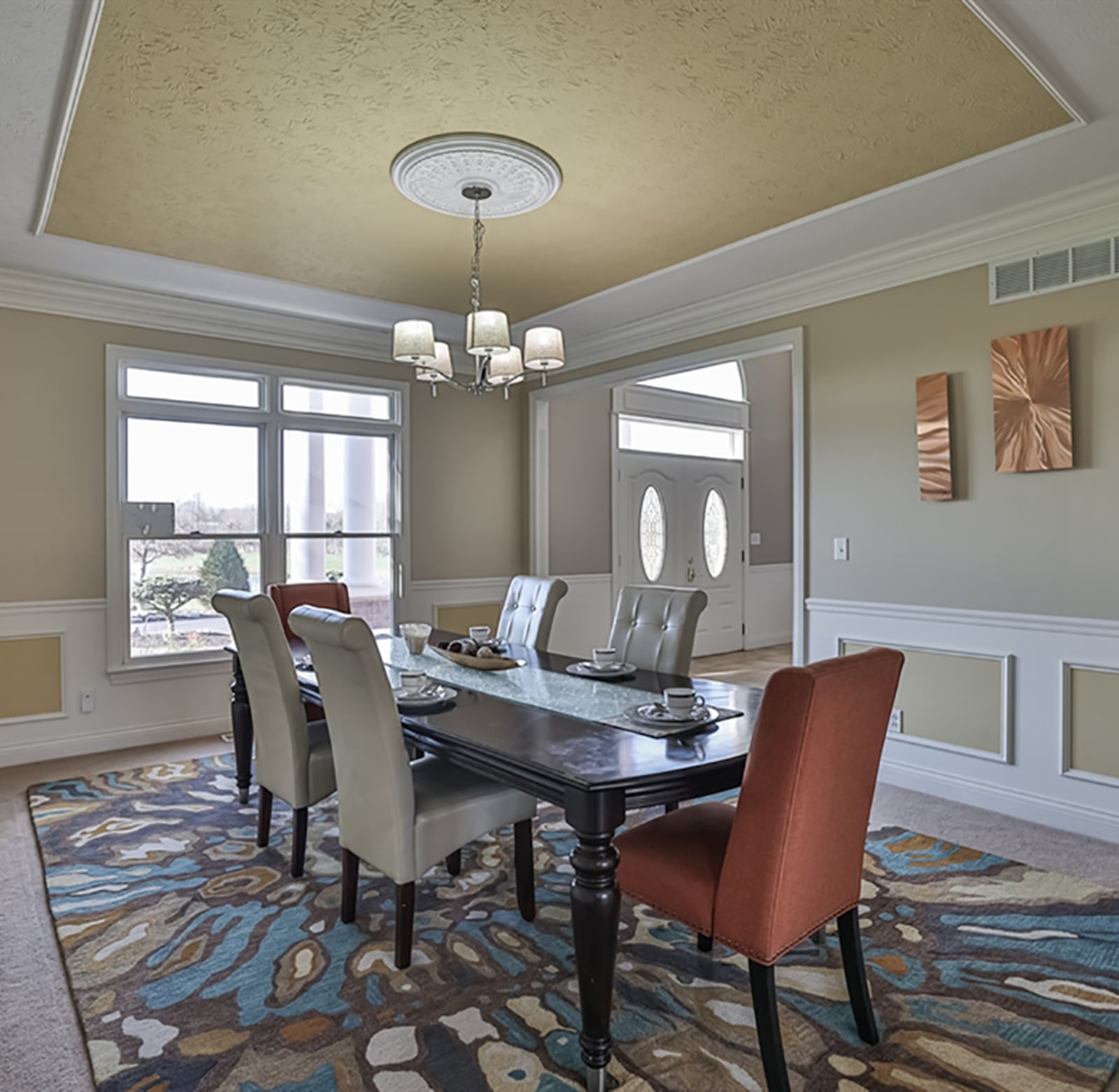 The formal dining room has an extended crown molding ceiling treatment, and a ceiling medallion encircles the hanging light fixture. Wainscoting accents the wall space and fluted threshold to the dining area from the foyer. CONTRIBUTED PHOTO