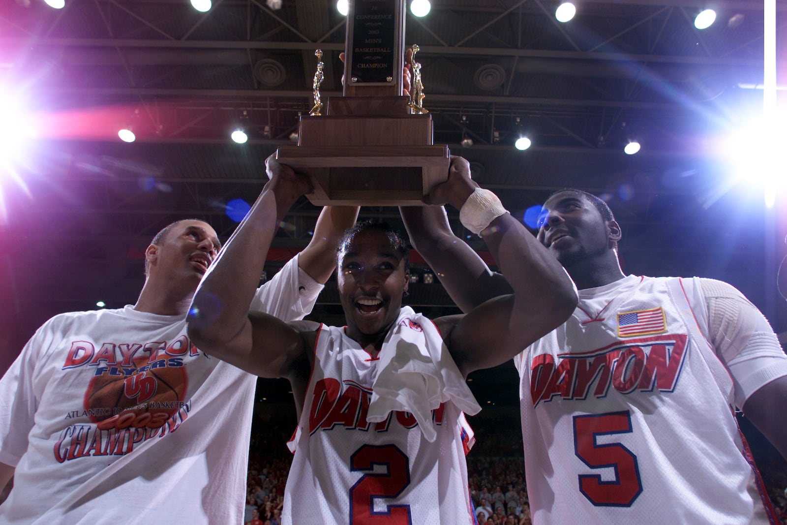 03/15/03  Dayton's Brooks Hall, D.J. Stelly, and Nate Green hold up the A-10 championship trophy after defeating Temple on Saturday afternoon.