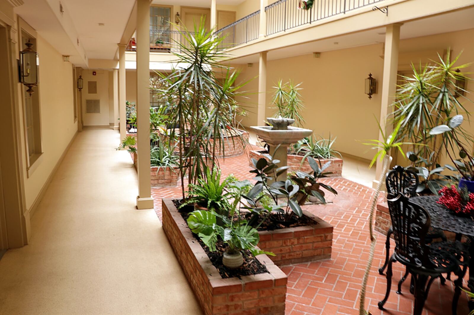 The first-floor condominium has interior access from a common area and outside access from the patio. Inside the building, the main level has a garden vista with paver-brick sitting areas, fountains, elevator to upper levels and access to other common spaces, including an exercise room. CONTRIBUTED PHOTO BY KATHY TYLER