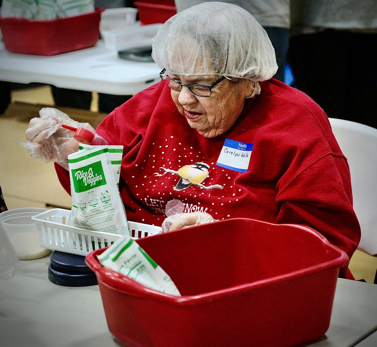 Carolyn Wolfe, helped to pack meals Saturday, Jan. 20, 2024 for third world countries at the Abiding Christ Church in Fairborn. MARSHALL GORBY\STAFF