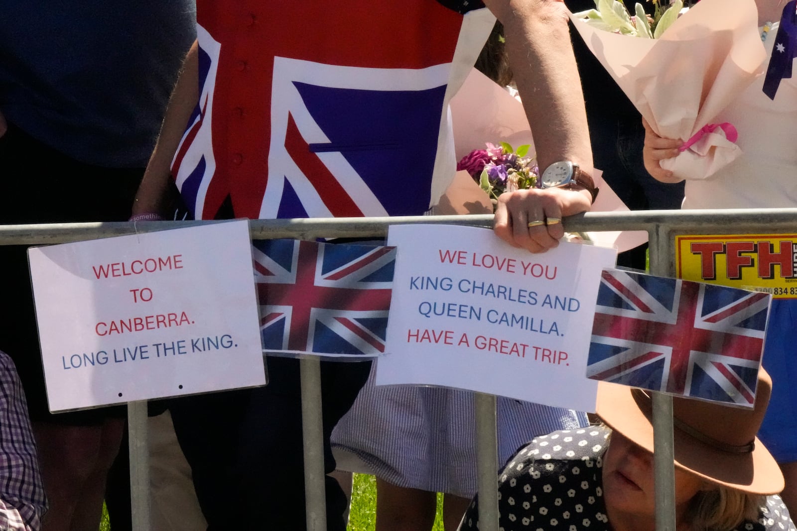 Royal supporters with greeting plate card to at Australian War Memorial to welcome Britain's King Charles and Queen Camilla visit in Canberra, Australia, Monday, Oct. 21, 2024. (AP Photo/Mark Baker, Pool)