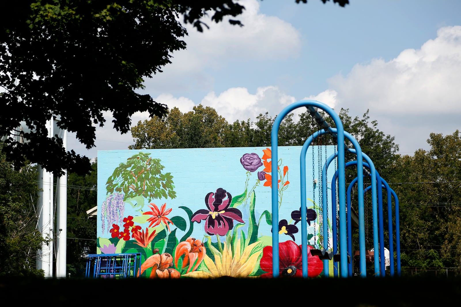 Vibrant blooming flowers have transformed a cement block shelter into a year-round garden at Nordale Park, 63  Nordale Ave., in Dayton's Belmont neighborhood. LISA POWELL / STAFF