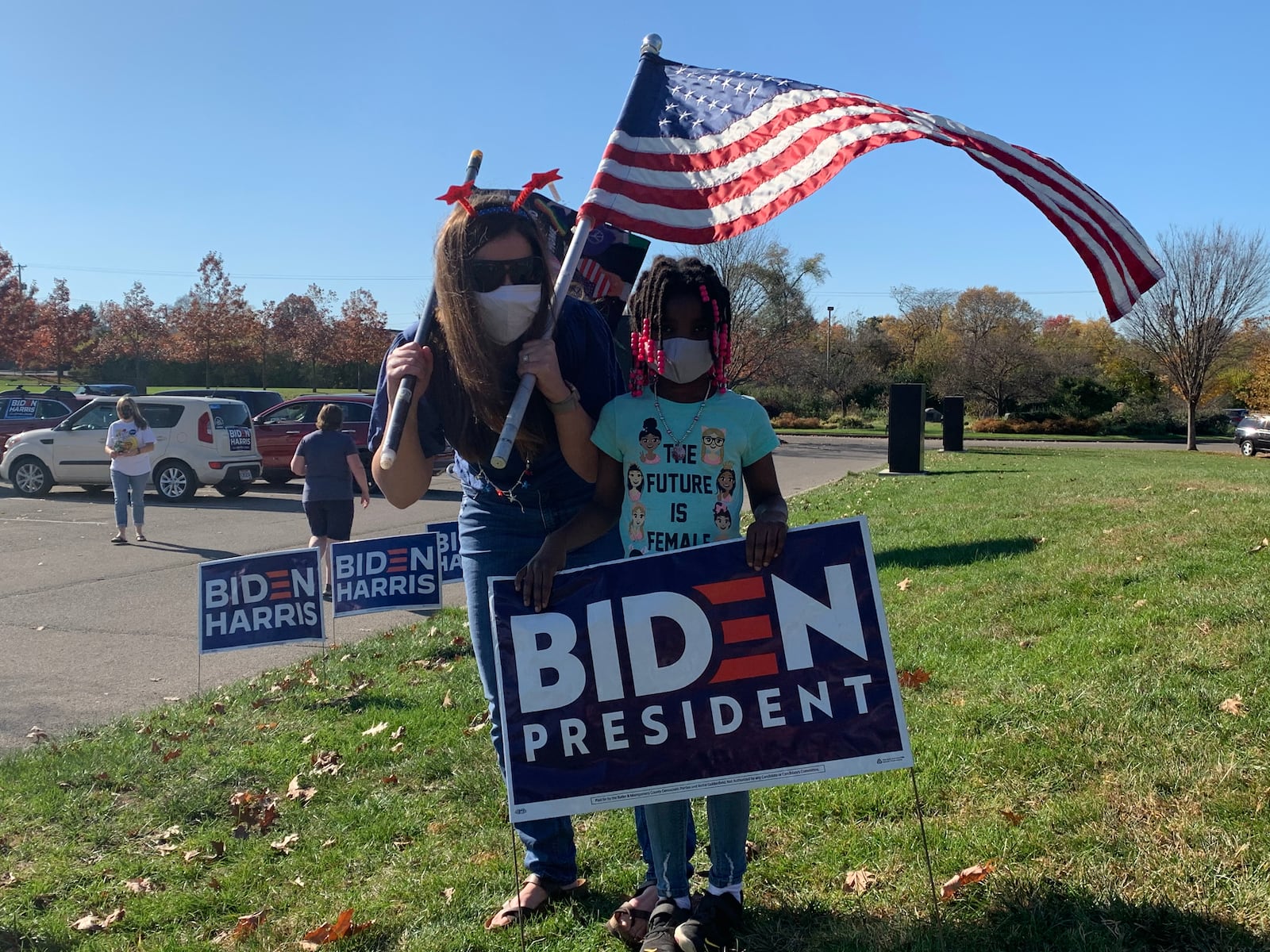 Jessica Bondurant and her daughter celebrate the apparent victory of President -Elect Joe Biden at a rally Sunday, Nov. 8, in Kettering. JOSH SWEIGART/STAFF