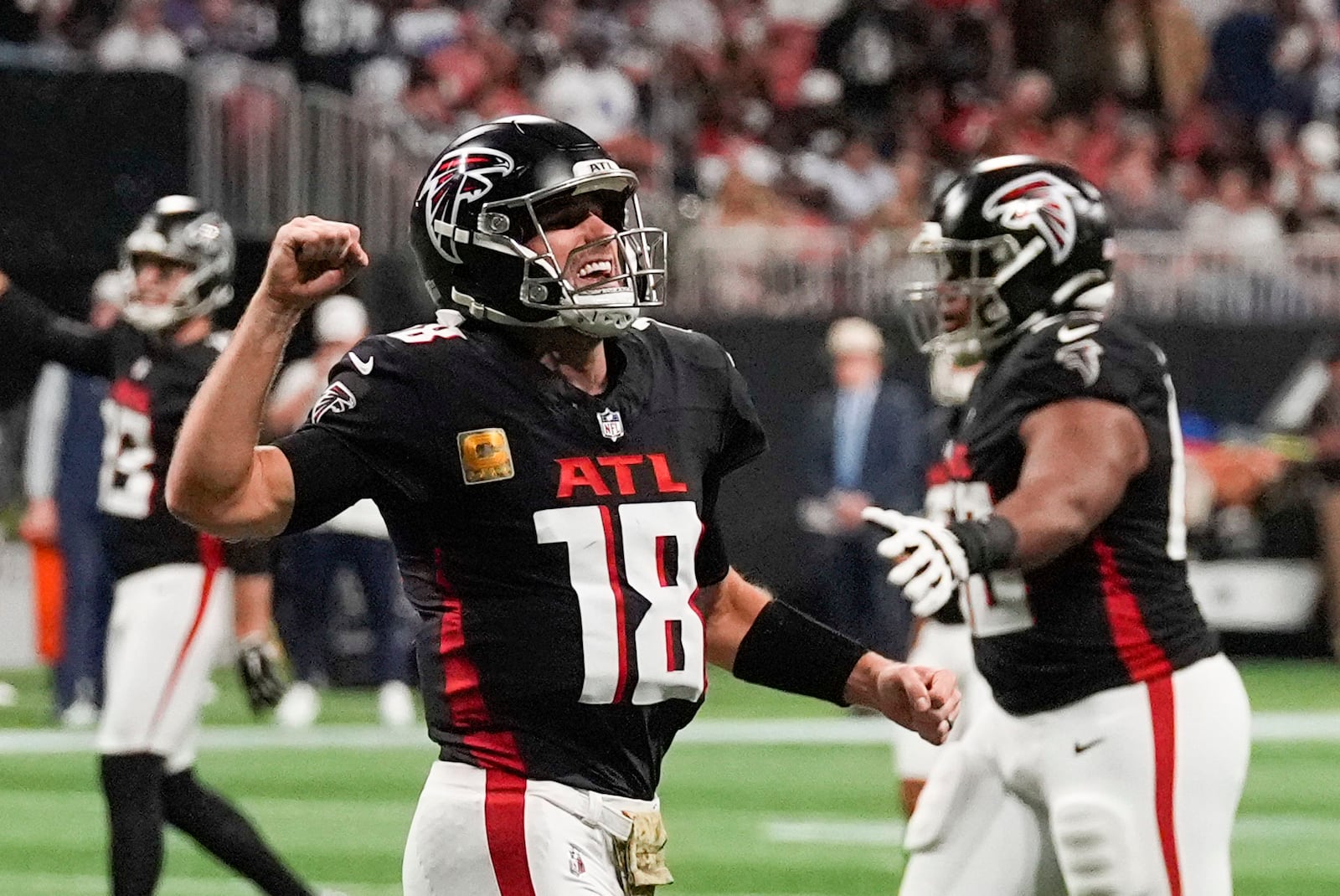 Atlanta Falcons quarterback Kirk Cousins (18) celebrates after a touchdown during the second half of an NFL football game against the Dallas Cowboys, Sunday, Nov. 3, 2024, in Atlanta. (AP Photo/ John Bazemore)