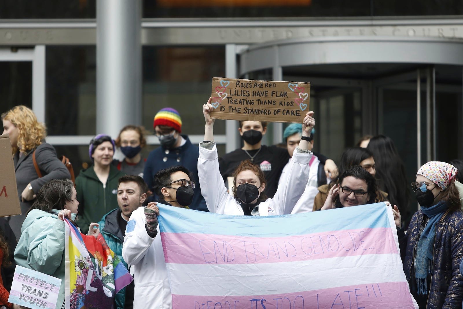 People celebrate outside a Seattle federal courthouse after a second federal judge paused President Donald Trump's order against gender-affirming care for youth on Friday, Feb. 14, 2025 in Seattle.. (AP Photo/Manuel Valdes)