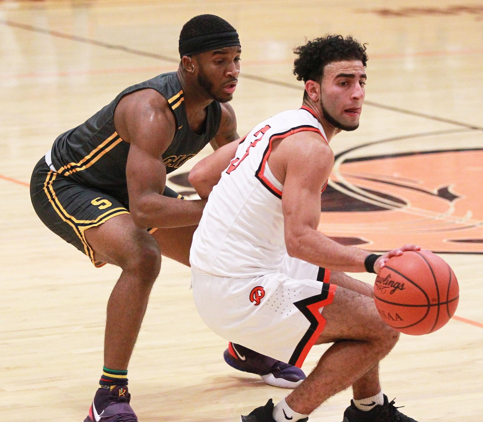 Yousef Saleh of Beavercreek (with ball) is checked by Larry Stephens of Beavercreek. Beavercreek defeated visiting Springfield 54-48 in a GWOC boys high school basketball game on Tuesday, Dec. 17, 2019. MARC PENDLETON / STAFF