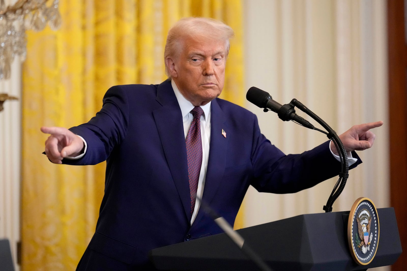 President Donald Trump points to a reporter and India's Prime Minister Narendra Modi during a news conference in the East Room of the White House, Thursday, Feb. 13, 2025, in Washington. (AP Photo/Ben Curtis)