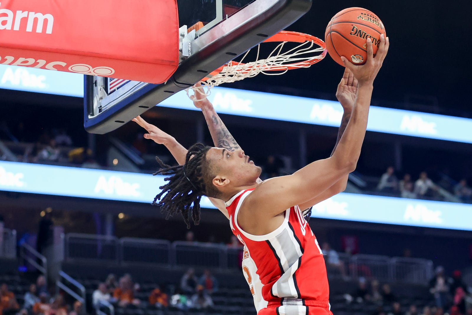 Ohio State forward Devin Royal (21) shoots against Texas guard Chendall Weaver (2) during the first half of an NCAA basketball game Monday, Nov. 4, 2024, in Las Vegas. (AP Photo/Ian Maule)