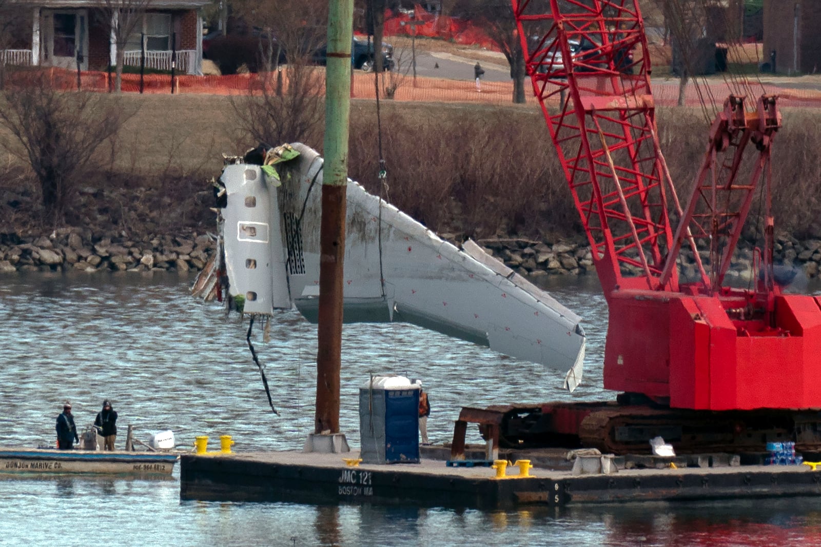 Rescue and salvage crews pull up airplane wreckage of an American Airlines jet in the Potomac River from Ronald Reagan Washington National Airport, Monday, Feb. 3, 2025, in Arlington, Va. (AP Photo/Jose Luis Magana)