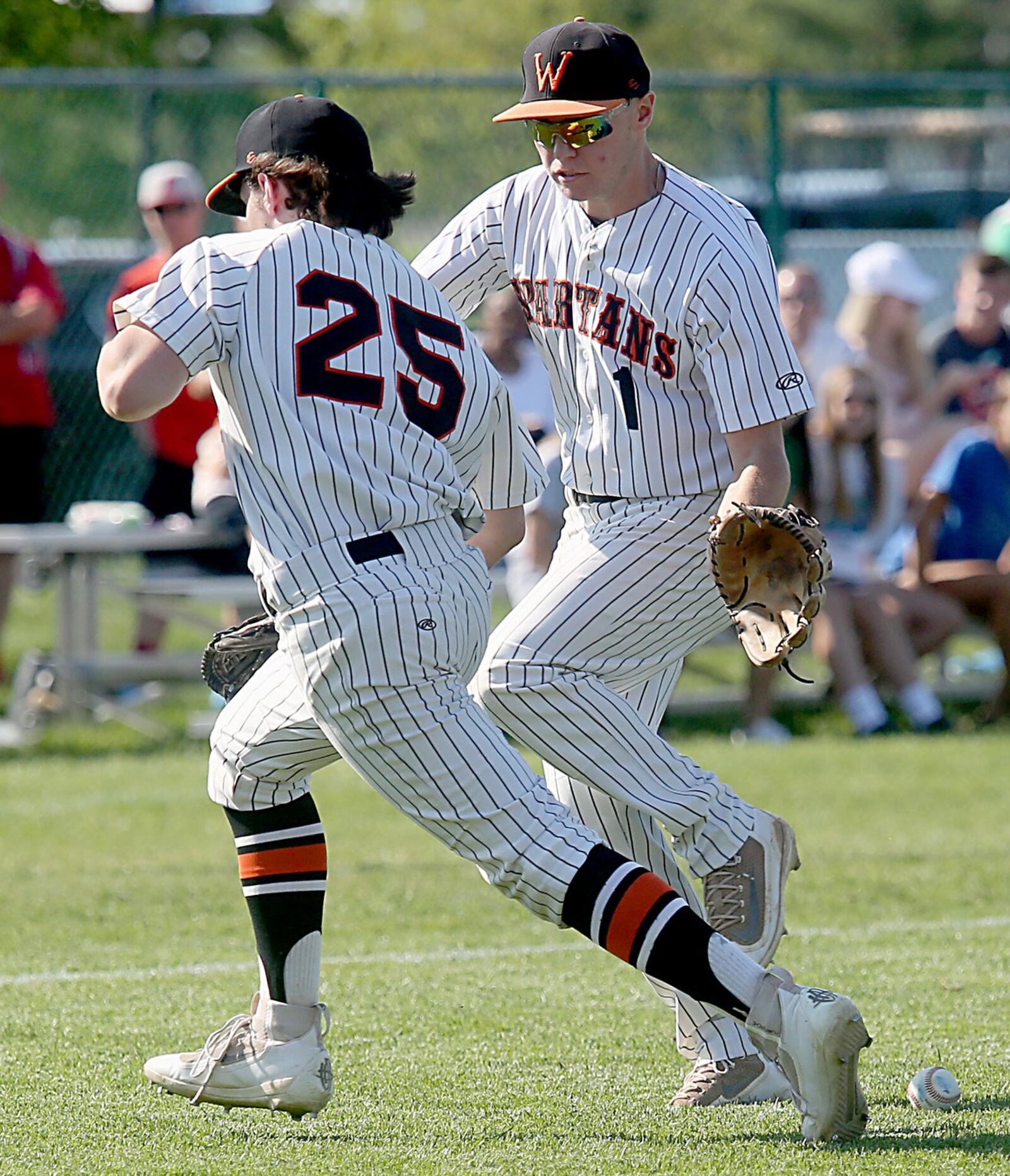 Waynesville pitcher Brady Stone (25) and third baseman Drake Stiles leave a Chaminade Julienne bunt untouched during their Division II regional semifinal Friday at Mason. CONTRIBUTED PHOTO BY E.L. HUBBARD